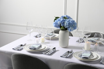 Beautiful table setting with floral decor indoors