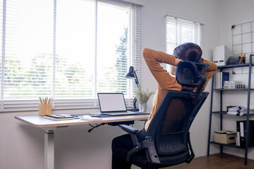 Young business asian woman work on laptop desk doing math finance on an office desk, tax, report, accounting, statistics, and analytical research concept