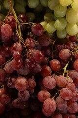 Many different fresh grapes as background, top view