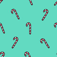 Caramel candy in the shape of a cane. Repeating vector pattern. Isolated green background. Sweet lollipop. Seamless ornament. Sweet background. Cartoon style. Festive print. Idea for web design