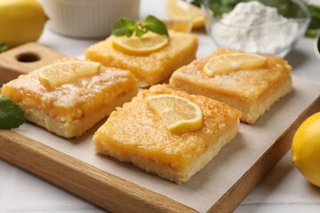 Tasty lemon bars on white table, closeup