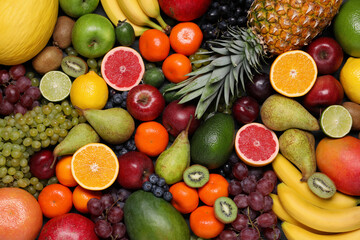 Different ripe fruits and berries as background, top view - obrazy, fototapety, plakaty