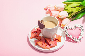 Valentine's Day romantic concept. Morning coffee, a bouquet of tulips, symbolic decor