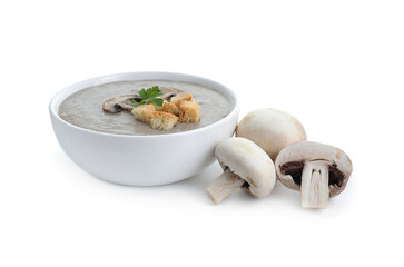 Delicious mushroom cream soup with croutons in bowl and mushrooms isolated on white