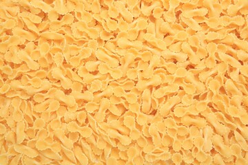Raw farfalle pasta as background, top view