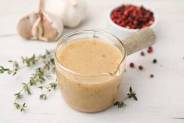 Delicious turkey gravy and thyme on white table, closeup