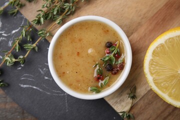 Delicious turkey gravy, thyme and peppercorns on table, top view