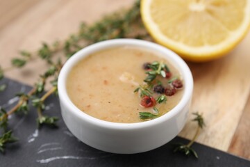 Delicious turkey gravy, thyme and peppercorns on table, closeup