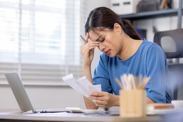 Frustrated desperate millennial woman checking bills for payments, holding receipts, getting upset...