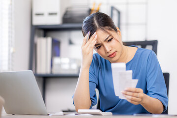 Frustrated desperate millennial woman checking bills for payments, holding receipts, getting upset...
