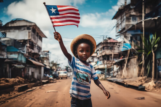 Liberian boy holding Liberia flag in Monrovia street
