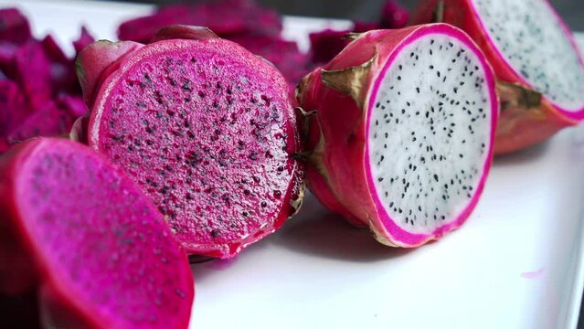 Panning shot Close up of Red and white dragonfruit Red Dragon Fruit Slices and Cultivating Exotic Plants pitaya