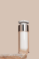Pump bottle mock up cosmetic product, glass jar with mirror, stand on natural stones with beige...