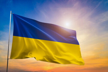 Ukraine national flag waving in beautiful clouds.
