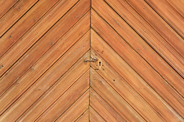 Metal latch on wooden barn door as wood background texture
