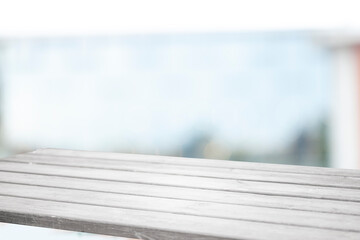 Perspective light empty wooden table from above on blurred background can be used mockup to display installation products or design layout.