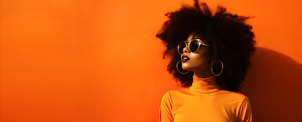 Cool and modern black woman wearing sunglasses on orange banner background.
