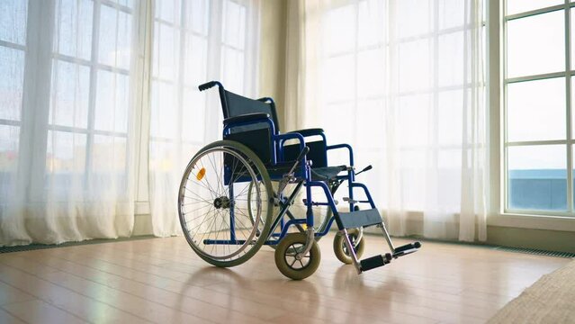 Empty wheelchair in clinic lobby. Wheelchair used for physical recovery service on health care insurance, paralyzed injured patients. Healthcare, medicine, medical objects helping to live concept.