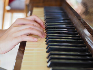 Playing an old wooden piano. Close-up.