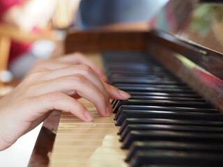 Playing an old wooden piano. Close-up.