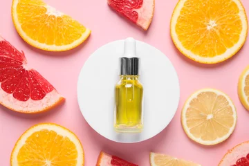 Foto op Plexiglas Bottle of cosmetic serum and citrus fruit slices on pink background, flat lay © New Africa
