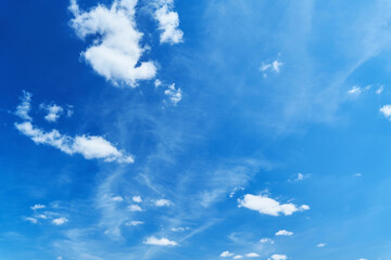 Clear blue sky with some small white clouds on sunny day