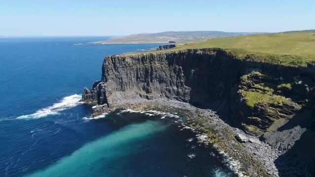A drone shot of the Cliffs of Moher, the tallest sea cliffs of the rugged West Clare Coast of Ireland.