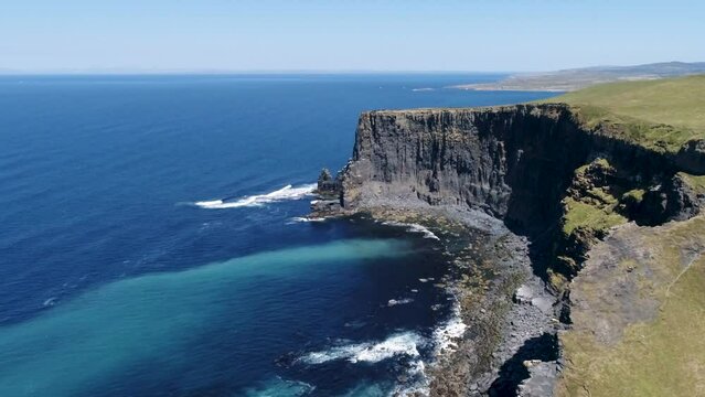 A drone shot of the Cliffs of Moher, the tallest sea cliffs of the rugged West Clare Coast of Ireland.