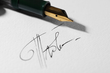 Fototapeta premium Sheet of paper with fountain pen and signature, closeup