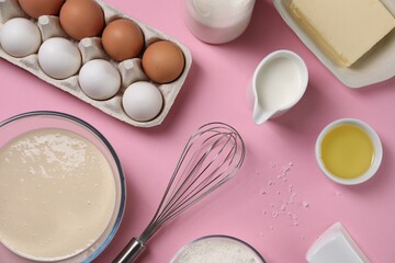 Flat lay composition with whisk and dough in bowl on pink background