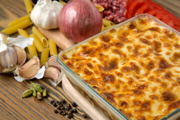 Pasta bechamel oven baked served in dish with minced meat, tomato, garlic, onion, black pepper and...