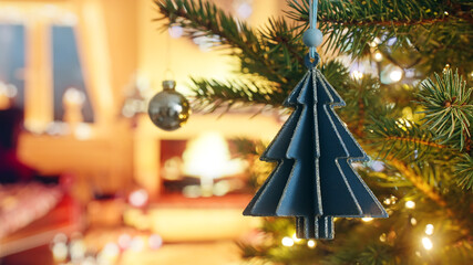 Christmas card decorative Christmas tree made paper close up hanging on branch of green spruce...
