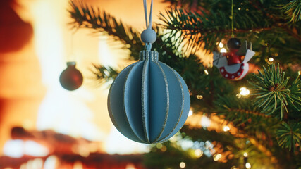 Christmas concept decorative paper ball rotate on branch tree on background bokeh of side flickering light bulbs garlands for family holiday Happy New Year. Festival mood. Positive emotion. Noel