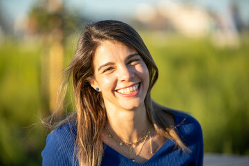 Cheerful woman laughing while enjoying outdoors.