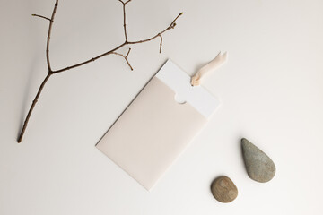 The composition of a dry glass with stones is photographed from above, a mockup with an envelope
