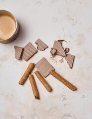 Dessert wafer and ceramic glass coffee on the decorative background style. Woman hand detail.