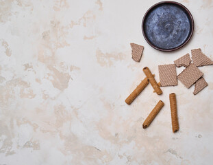 Ceramic plate and dessert wafer style on the white decorative background style, up view.