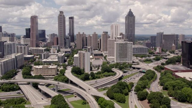 Aerial Backward Shot Of Cars Moving On Roads By Modern Buildings In City - Atlanta, Georgia