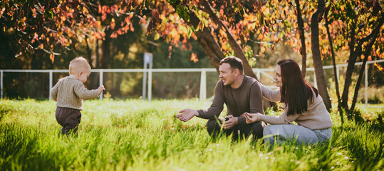 Portrait happy family mom dad and son having fun and enjoying spending time together in autumn park...