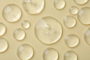 Samples of cosmetic serum on beige background, flat lay