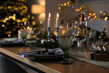 Christmas table setting with festive decor and dishware indoors