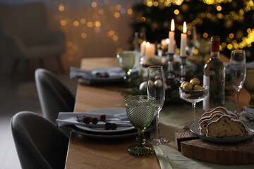 Christmas table setting with festive decor and dishware indoors
