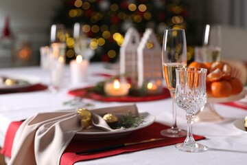 Christmas table setting with beautiful napkin, cutlery and dishware indoors
