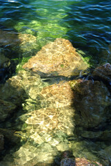 Sunlight Reflected on Rocks beneath Clear Waters of Shallow 