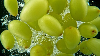 Bunch of Fresh Grapes of Wine Dropped in Water.