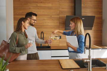 Shop assistant offering customers fresh filtered purified water from a tap for drinking
