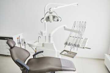 Dentist's office interior with modern chair and special dentisd equipment. Dentist office. Dentist chair in high class dental clinic. Dentist office. Medical concept.