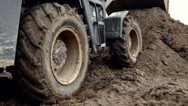 machinery in construction site, heavy civil engineering work on ground, loader loading ground