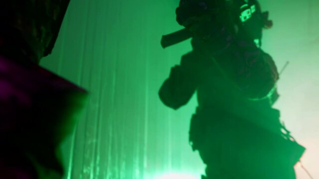 professional soldiers with weapons performing assault of building, active cinematic shot