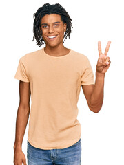 Young african american man wearing casual clothes showing and pointing up with fingers number two while smiling confident and happy.